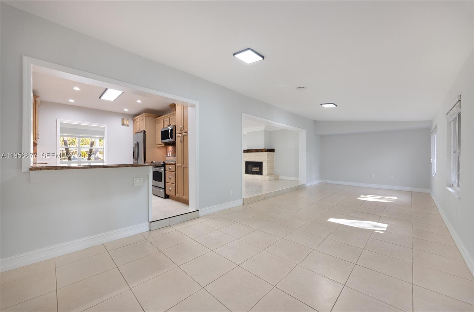 5730 Southwest 56th Terrace Miami, FL 33143 - Photo 7 of 18 an empty room with kitchen and windows