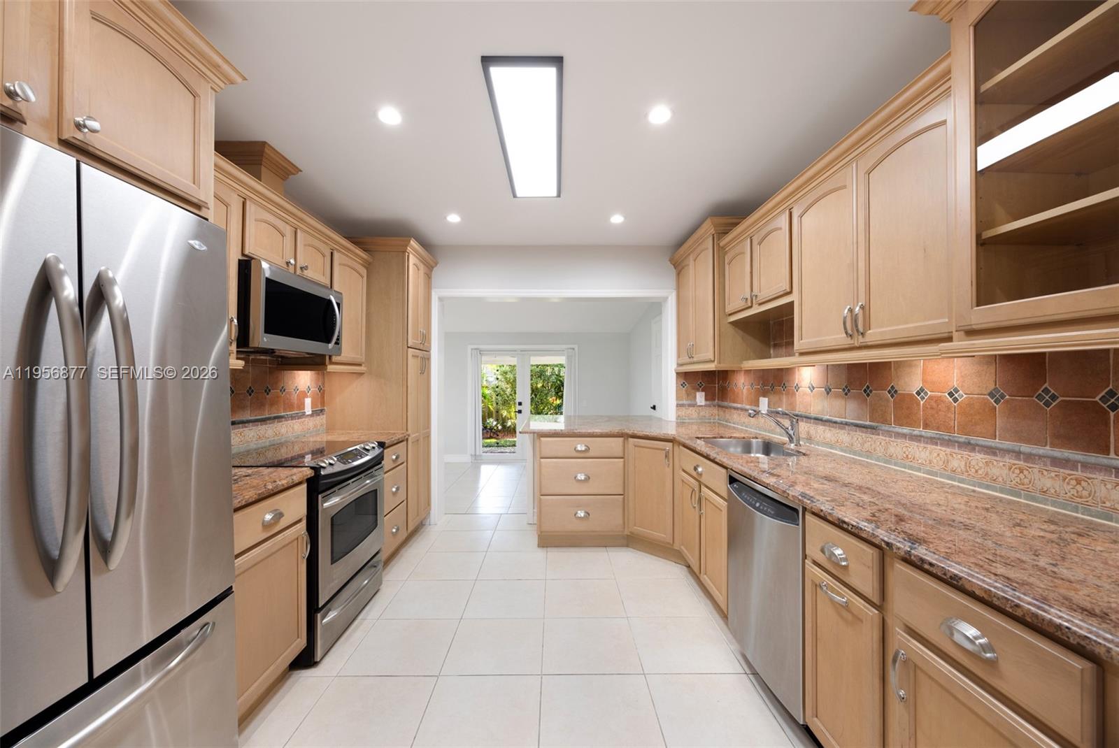 5730 Southwest 56th Terrace Miami, FL 33143 - Photo 8 of 18 a large kitchen with stainless steel appliances granite countertop a refrigerator and a stove top oven