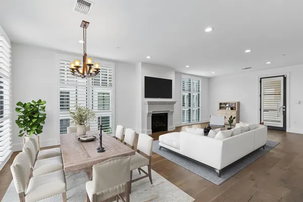 a living room with furniture a chandelier a fireplace and a chandelier