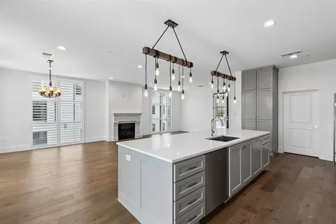 a kitchen with sink stove and refrigerator