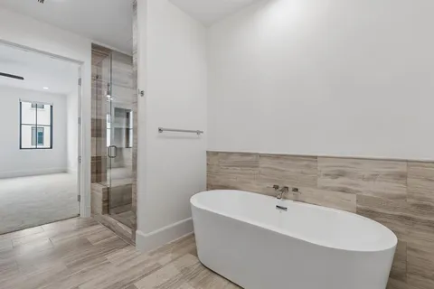 a bathroom with a bathtub and shower
