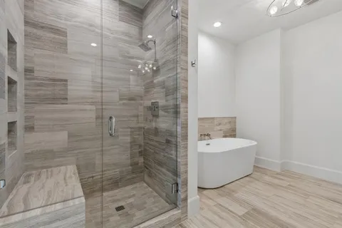 a bathroom with a bathtub and shower