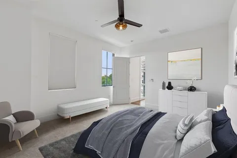a bedroom with a bed couch and window
