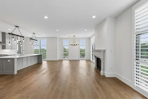 a view of a kitchen with a sink and a fireplace