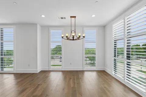 a view of wooden floor and chandelier in a room
