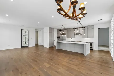 a view of a kitchen with a sink and cabinet with wooden floor