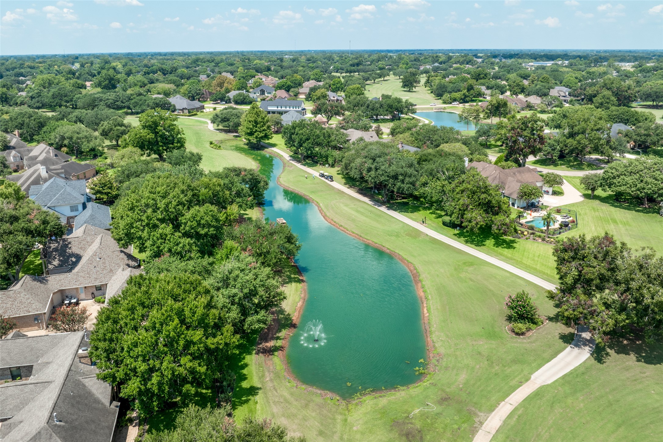 5303 Windrush Street Fulshear, TX 77441 - Photo 9 of 21 a view of a green yard with large trees