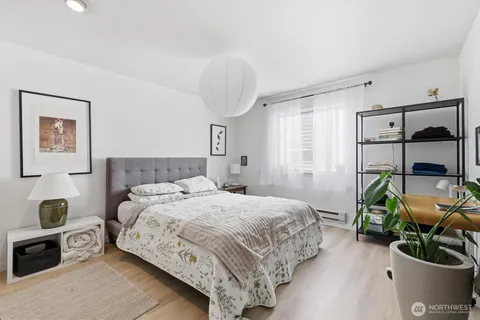 a bedroom with a bed and a mirror