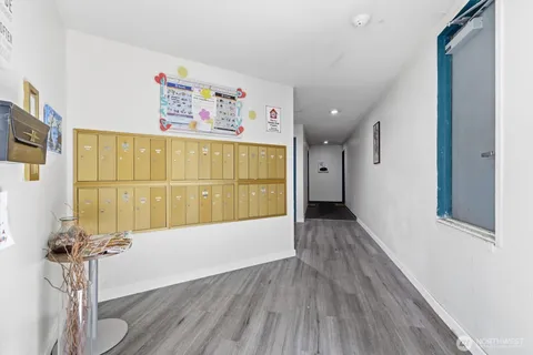 a view of a hallway with wooden floor