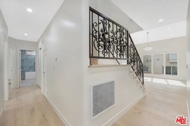 a view of entryway and hall with a front door