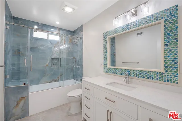a bathroom with a bathtub shower sink mirror and toilet
