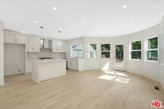 a view of kitchen with windows and refrigerator
