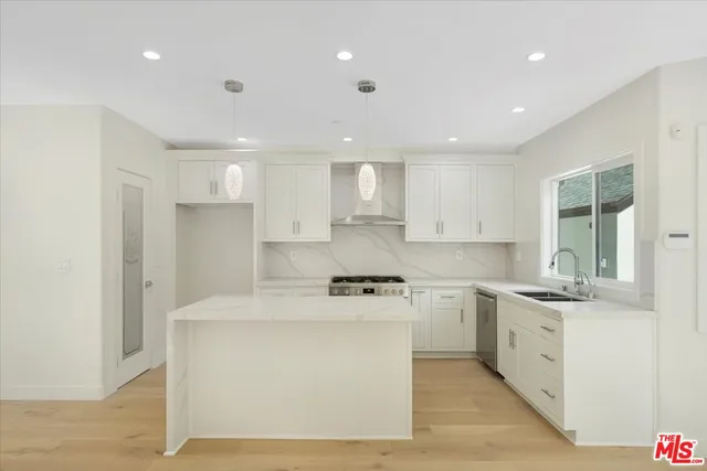 a kitchen with a sink stainless steel appliances and cabinets