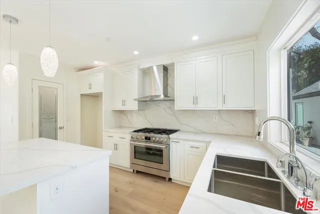 a kitchen with wooden cabinets and a stove top oven