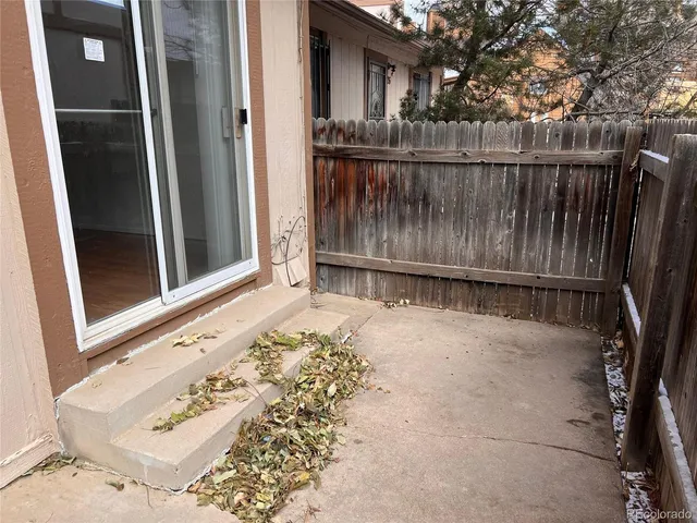 an empty room with wooden floor and sliding door