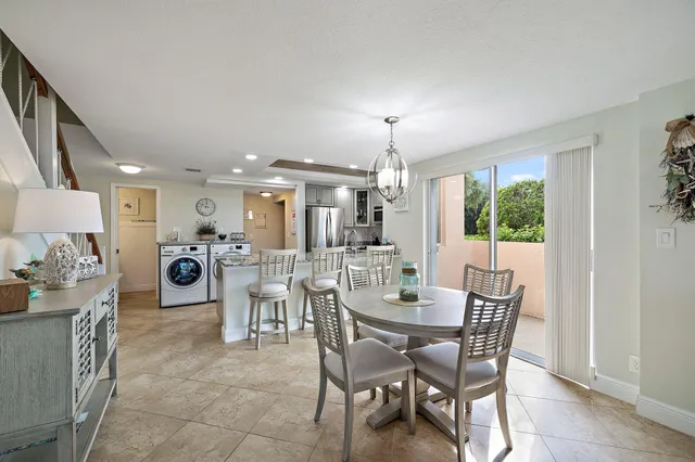 a view of a dining room with furniture and chandelier
