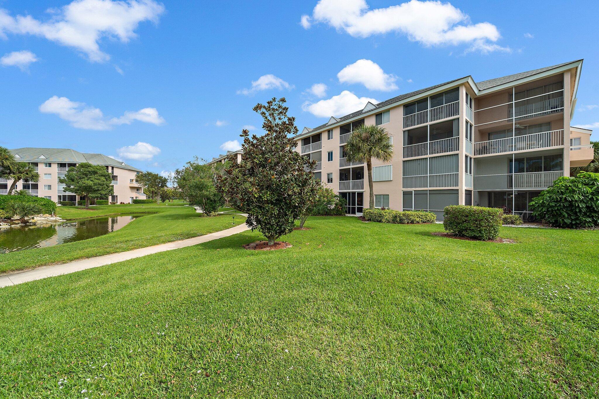 353 Highway 1, Unit D101 Jupiter, FL 33477 - Photo 2 of 32 a view of a house with a big yard and potted plants