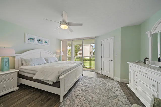 a spacious bedroom with a bed and a dresser