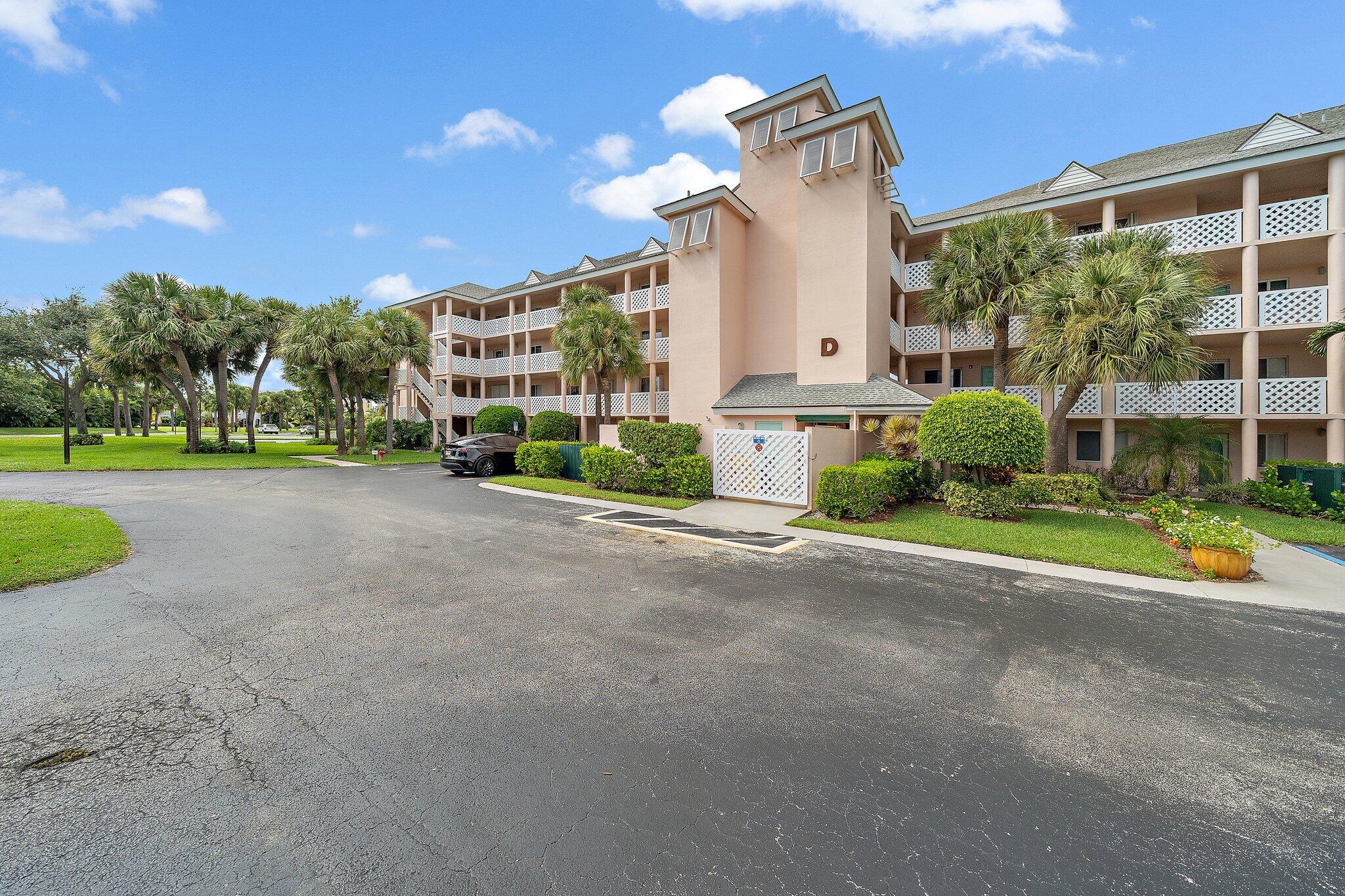 353 Highway 1, Unit D101 Jupiter, FL 33477 - Photo 30 of 32 a view of a house with a yard and potted plants