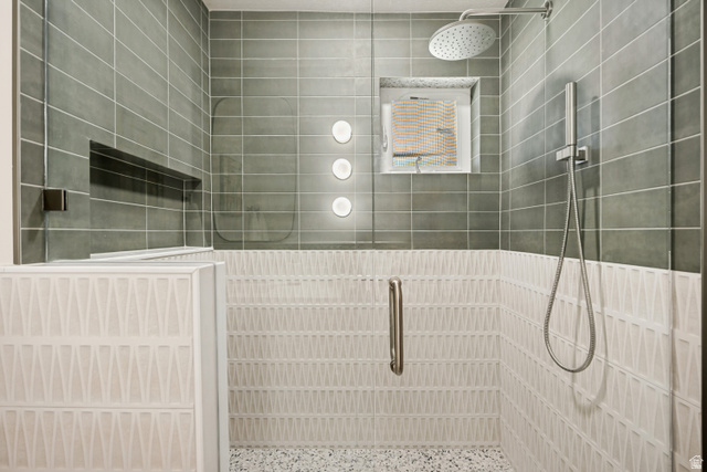 1168 East Center Street Bountiful, UT 84010 - Photo 19 of 38 Walk-in shower featuring a rain shower head, handheld shower fixture, and a built-in niche