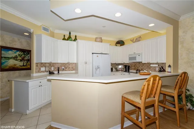 a kitchen with cabinets a sink and appliances