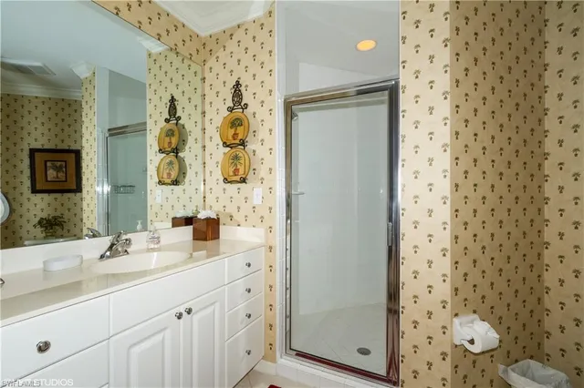 a bathroom with a double vanity sink mirror and shower