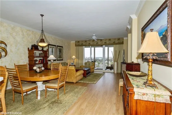 a living room with furniture a window and a dining table
