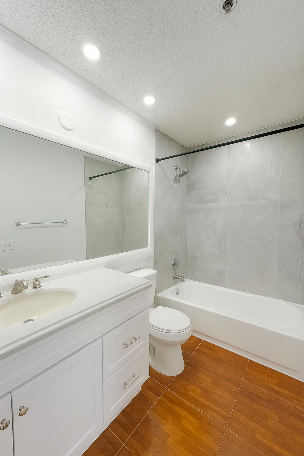 2303 North Congress Avenue, Unit 38 Boynton Beach, FL 33426 - Photo 10 of 11 a spacious bathroom with a double vanity sink a toilet and a bathtub