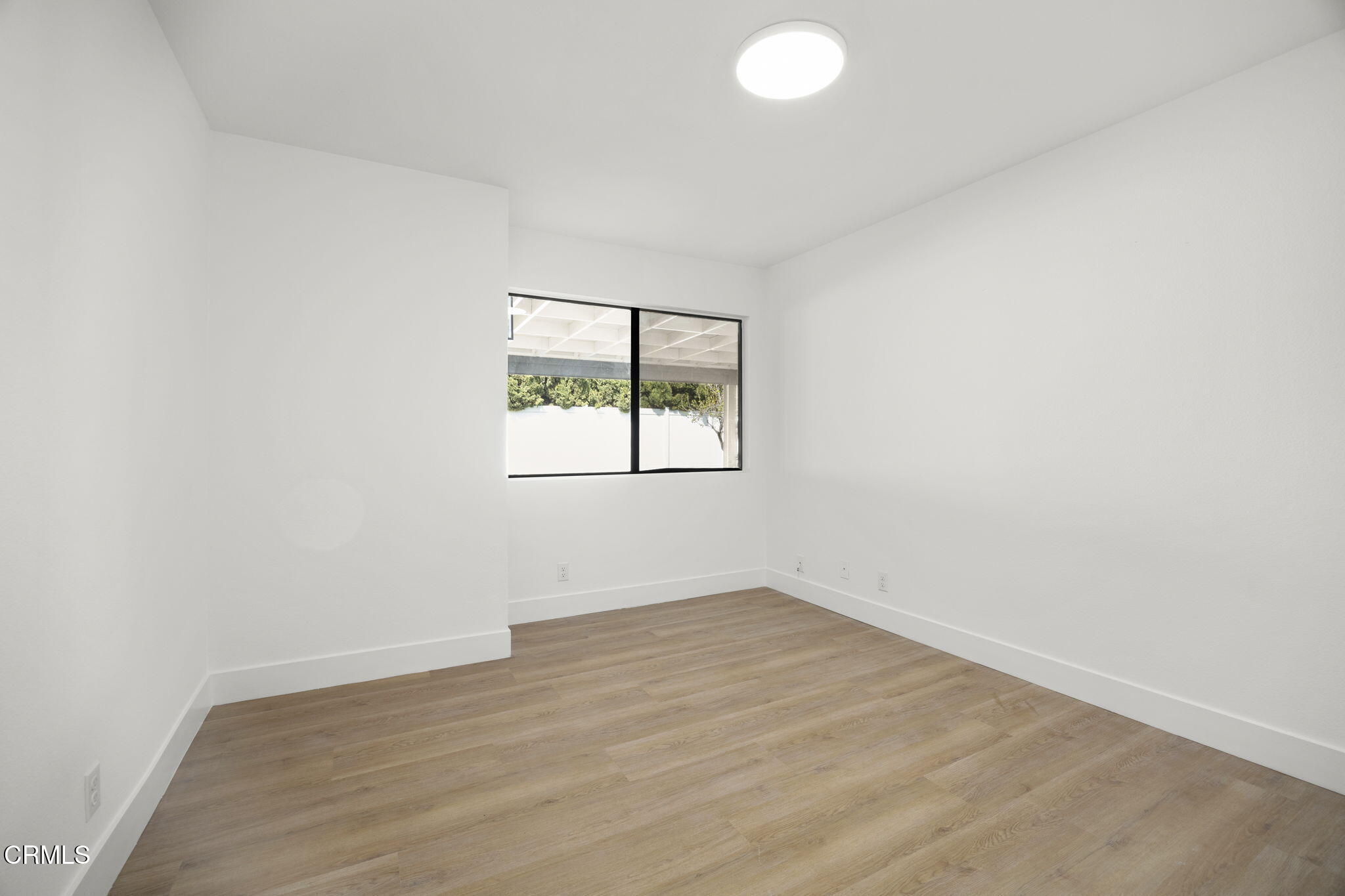 921 Juneberry Place Oxnard, CA 93036 - Photo 16 of 20 an empty room with wooden floor and windows