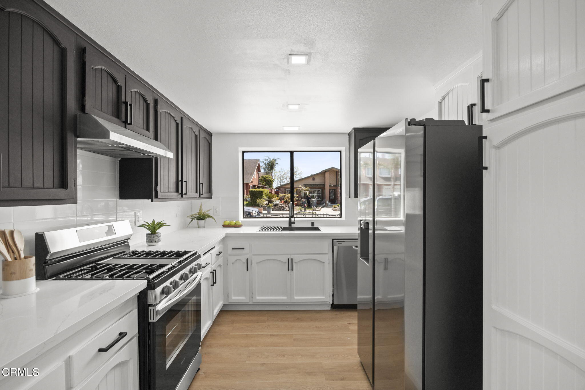 921 Juneberry Place Oxnard, CA 93036 - Photo 9 of 20 a kitchen with stainless steel appliances a stove refrigerator sink and cabinets