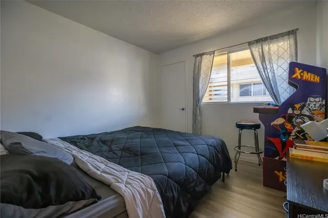 a bed sitting in a bedroom next to a window
