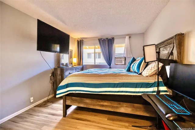 a bedroom with a bed and flat screen tv