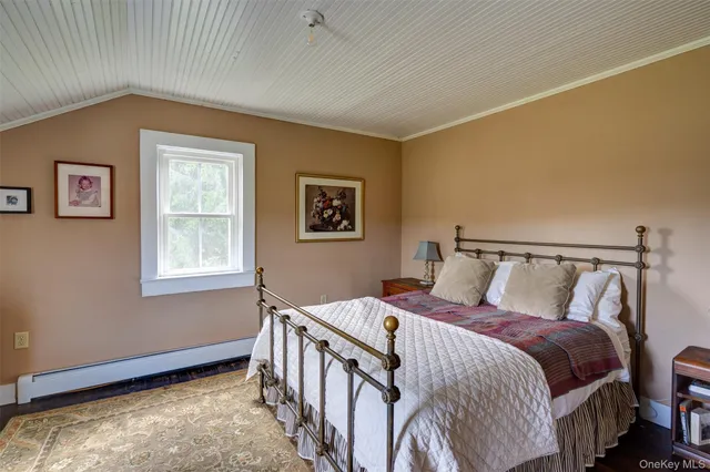 a bedroom with bed and wooden floor