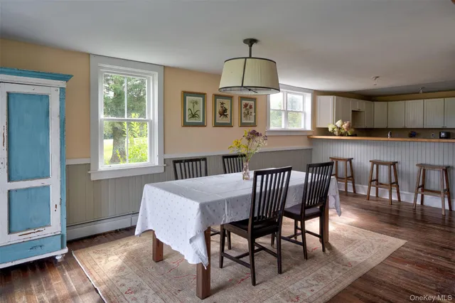 a view of a dining room with furniture window and wooden floor
