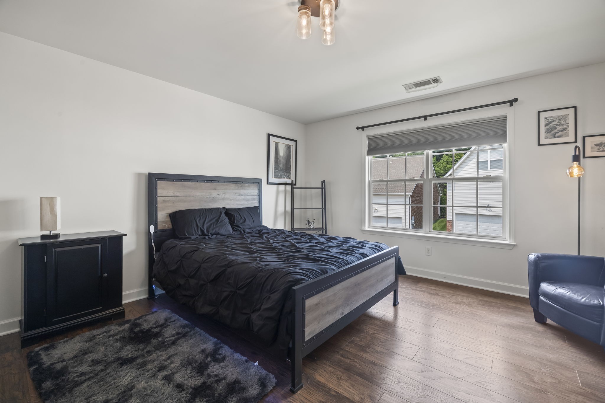 1305 Decatur Circle Franklin, TN 37067 - Photo 22 of 29 a bedroom with a bed and wooden floor