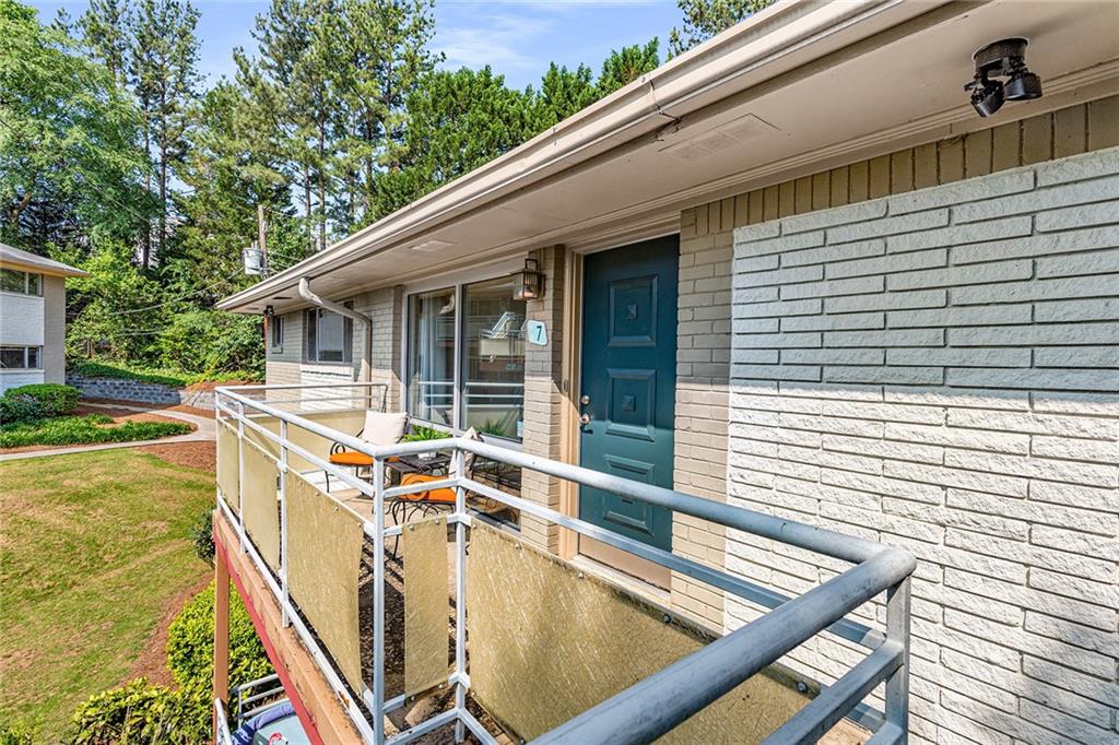 3048 Briarcliff Road Northeast, Unit 7 Atlanta, GA 30329 - Photo 1 of 1 a view of a patio with a table and chairs