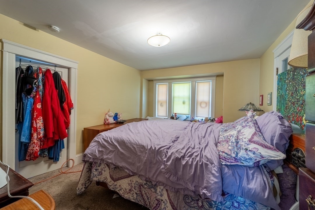 8 Lamar Avenue Worcester, MA 01604 - Photo 12 of 26 a bed sitting in a bedroom next to a window