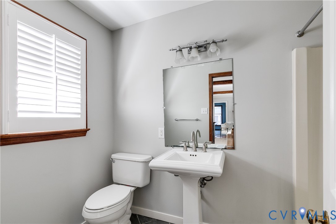 4808 Stuart Avenue Richmond, VA 23226 - Photo 23 of 41 a bathroom with a sink a toilet and mirror