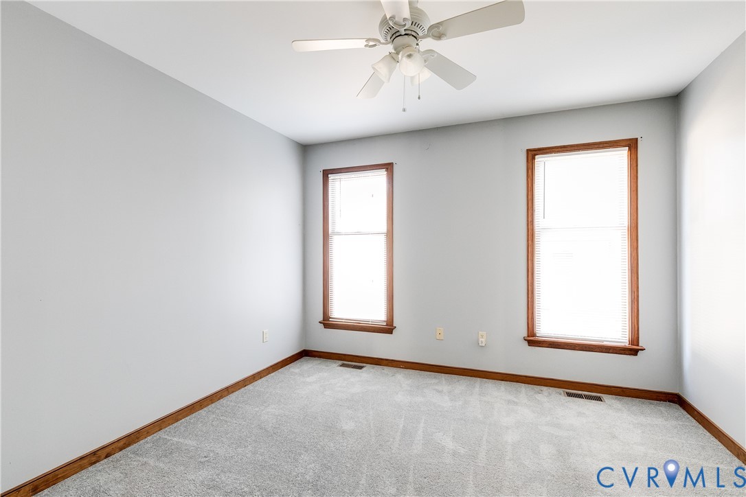 4808 Stuart Avenue Richmond, VA 23226 - Photo 25 of 41 an empty room with windows and fan