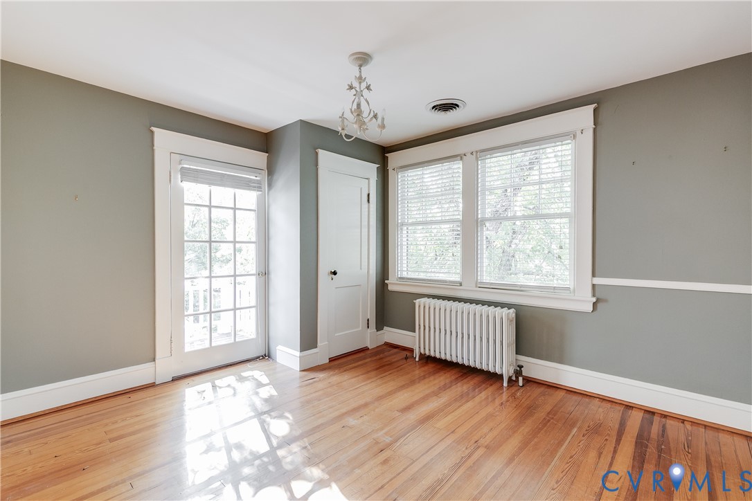 4808 Stuart Avenue Richmond, VA 23226 - Photo 31 of 41 an empty room with wooden floor and windows