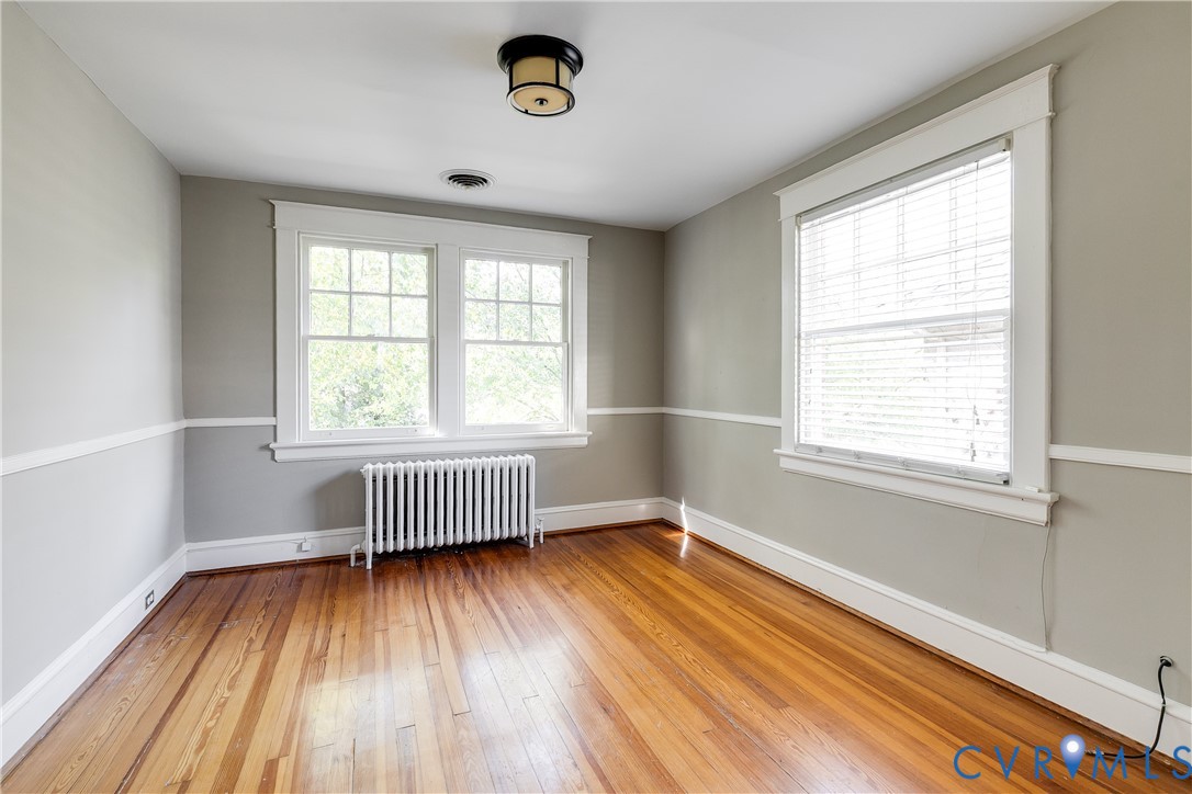 4808 Stuart Avenue Richmond, VA 23226 - Photo 33 of 41 an empty room with wooden floor and windows