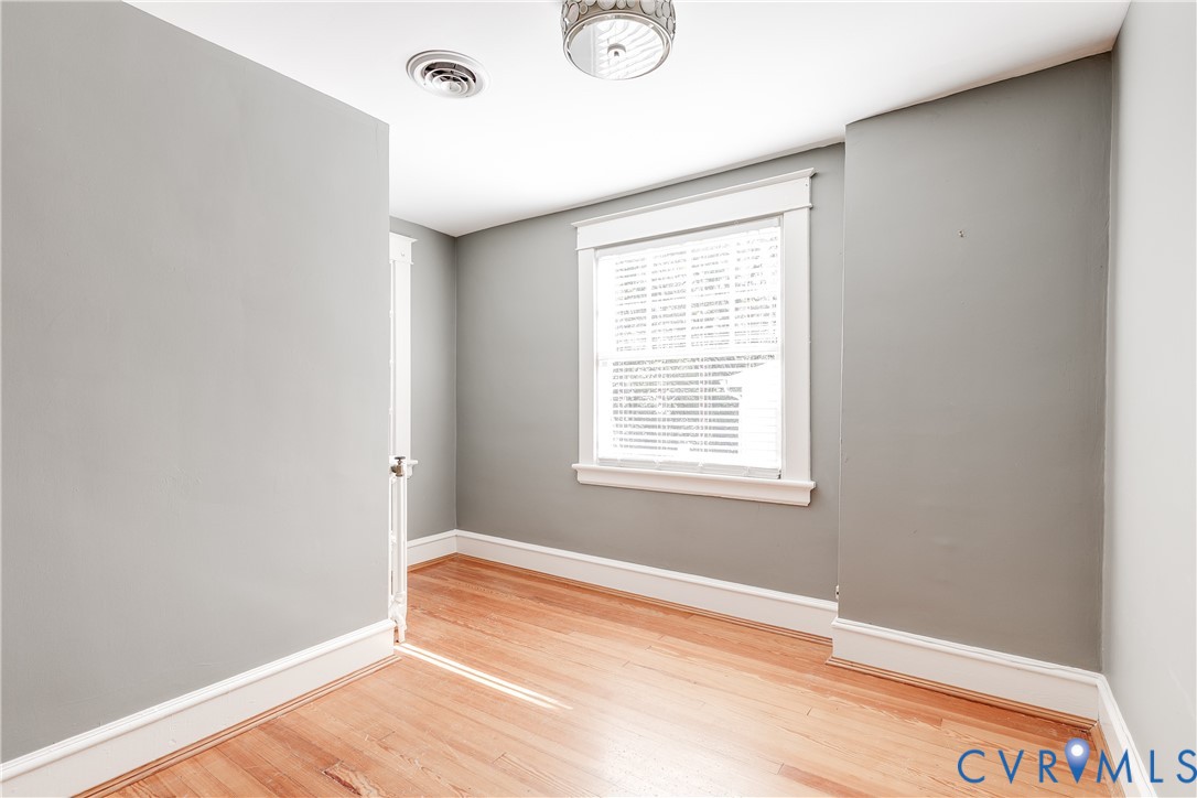 4808 Stuart Avenue Richmond, VA 23226 - Photo 34 of 41 a view of an empty room with wooden floor and a window