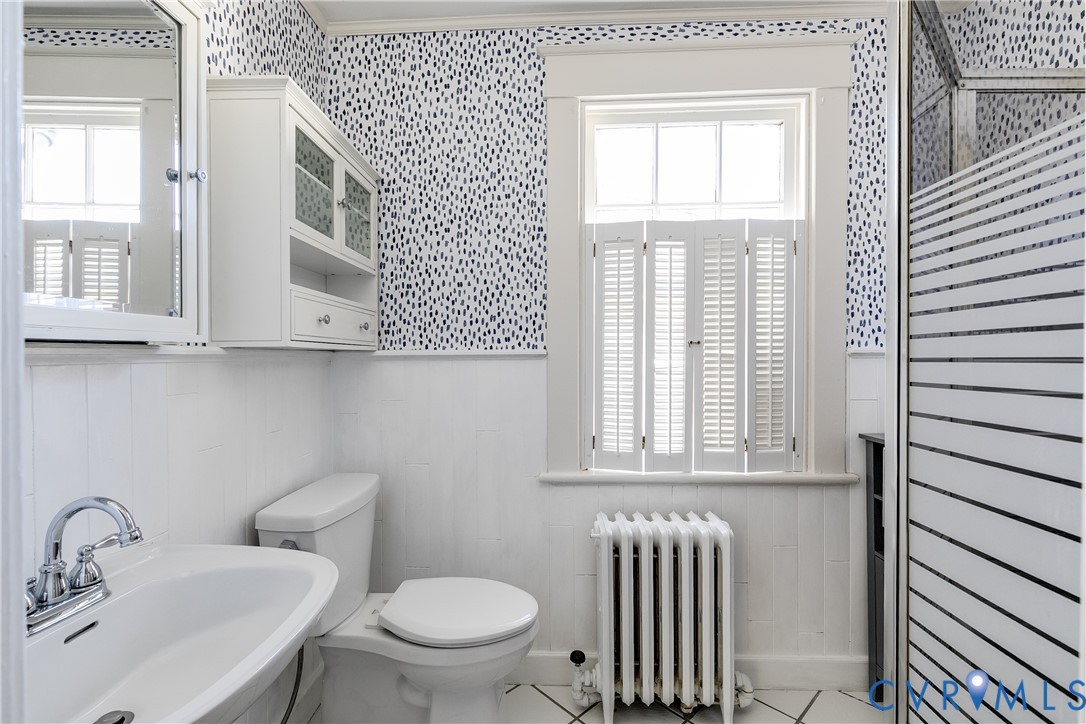 4808 Stuart Avenue Richmond, VA 23226 - Photo 36 of 41 a bathroom with a sink a toilet and a window