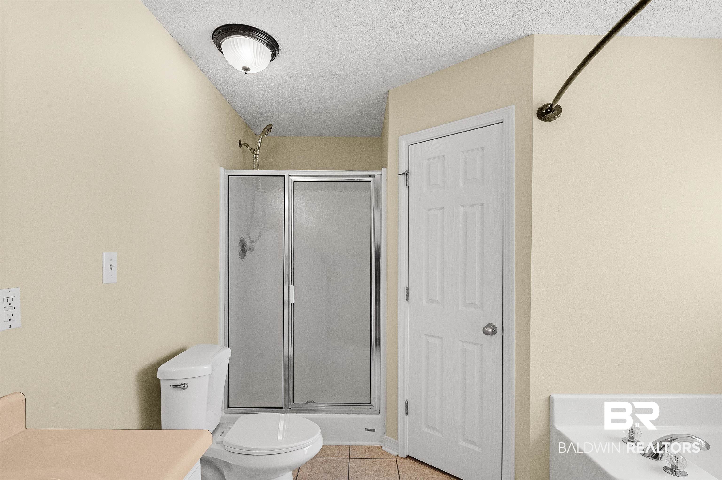 12443 Venice Boulevard Foley, AL 36535 - Photo 45 of 59 Full bathroom with vanity, toilet, independent shower and bath, and tile patterned flooring
