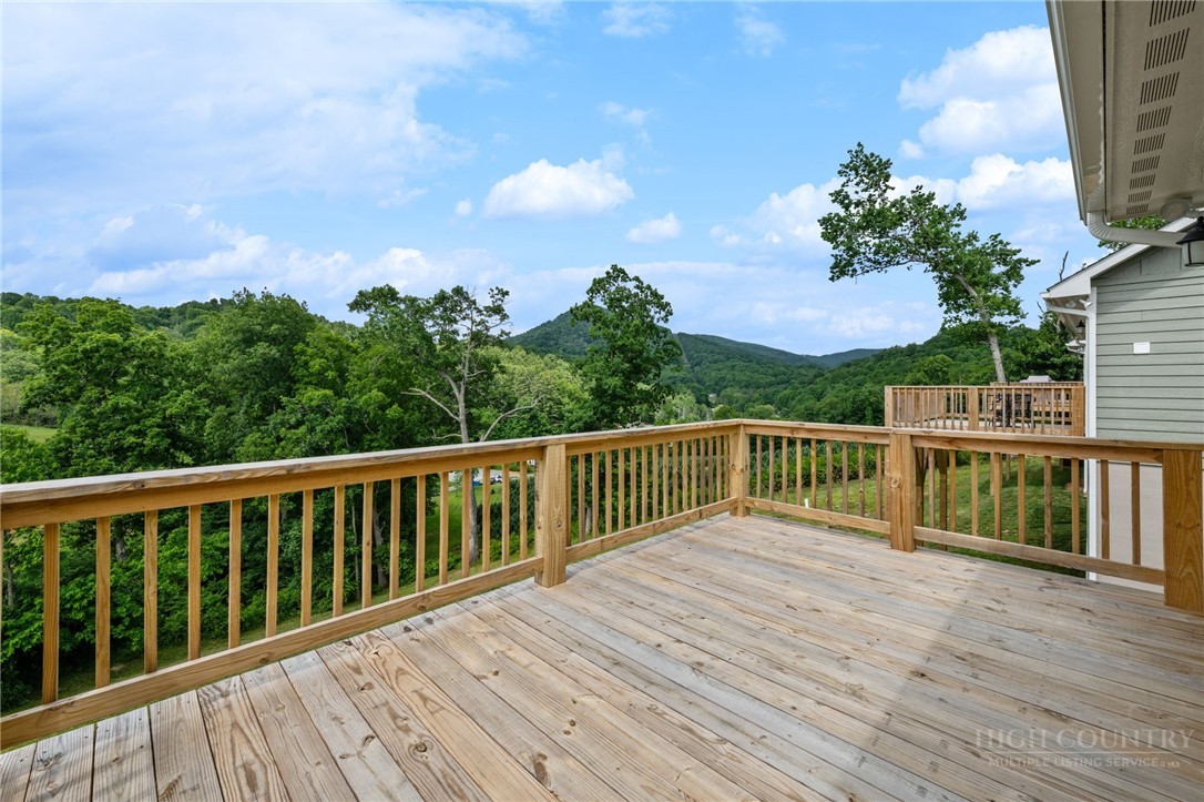 245 Ava Way, Unit 108 Boone, NC 28607 - Photo 7 of 31 a balcony with wooden floor and fence
