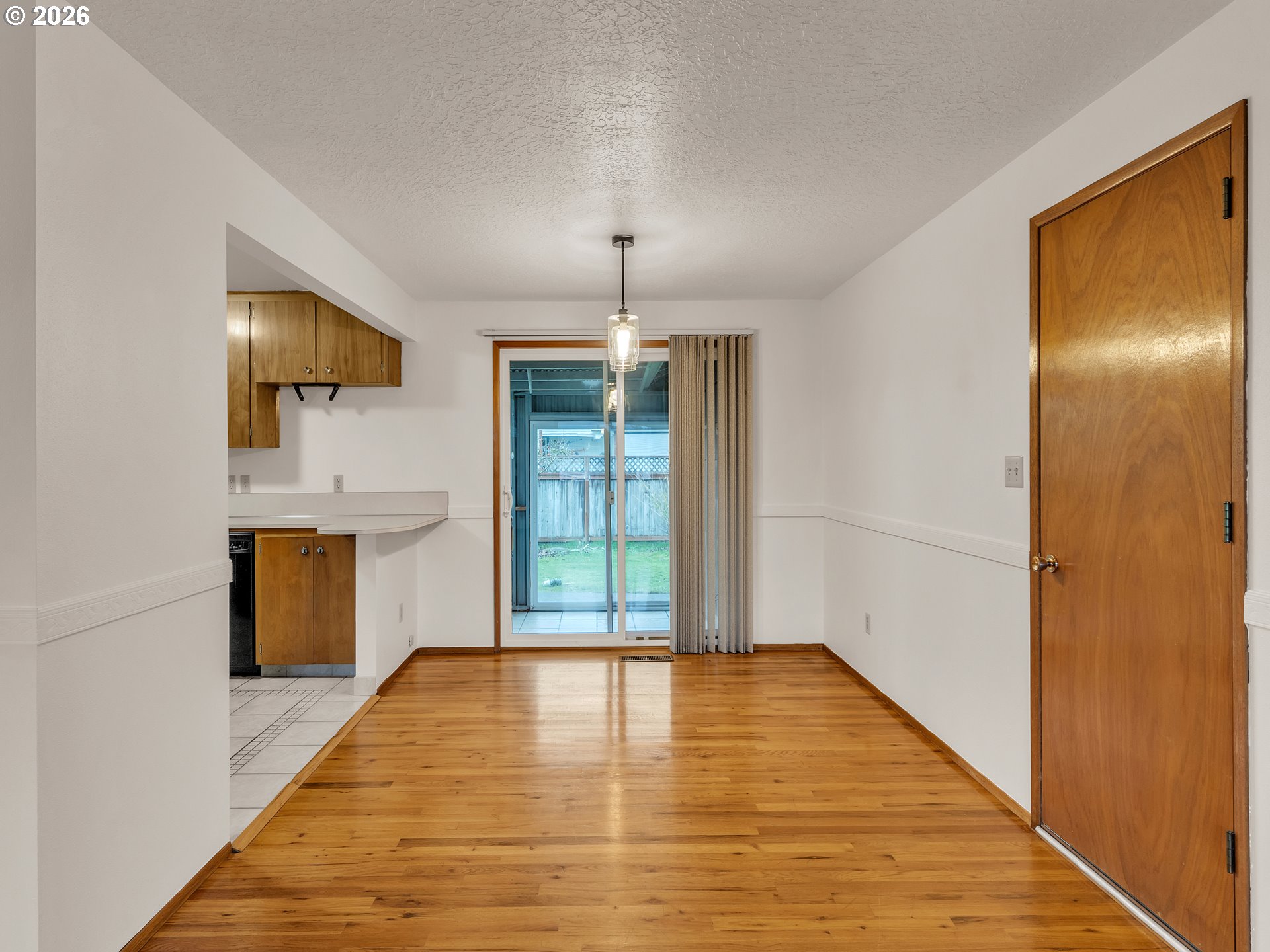 1749 Thompson Road Woodburn, OR 97071 - Photo 14 of 33 a view of an empty room with window and wooden floor