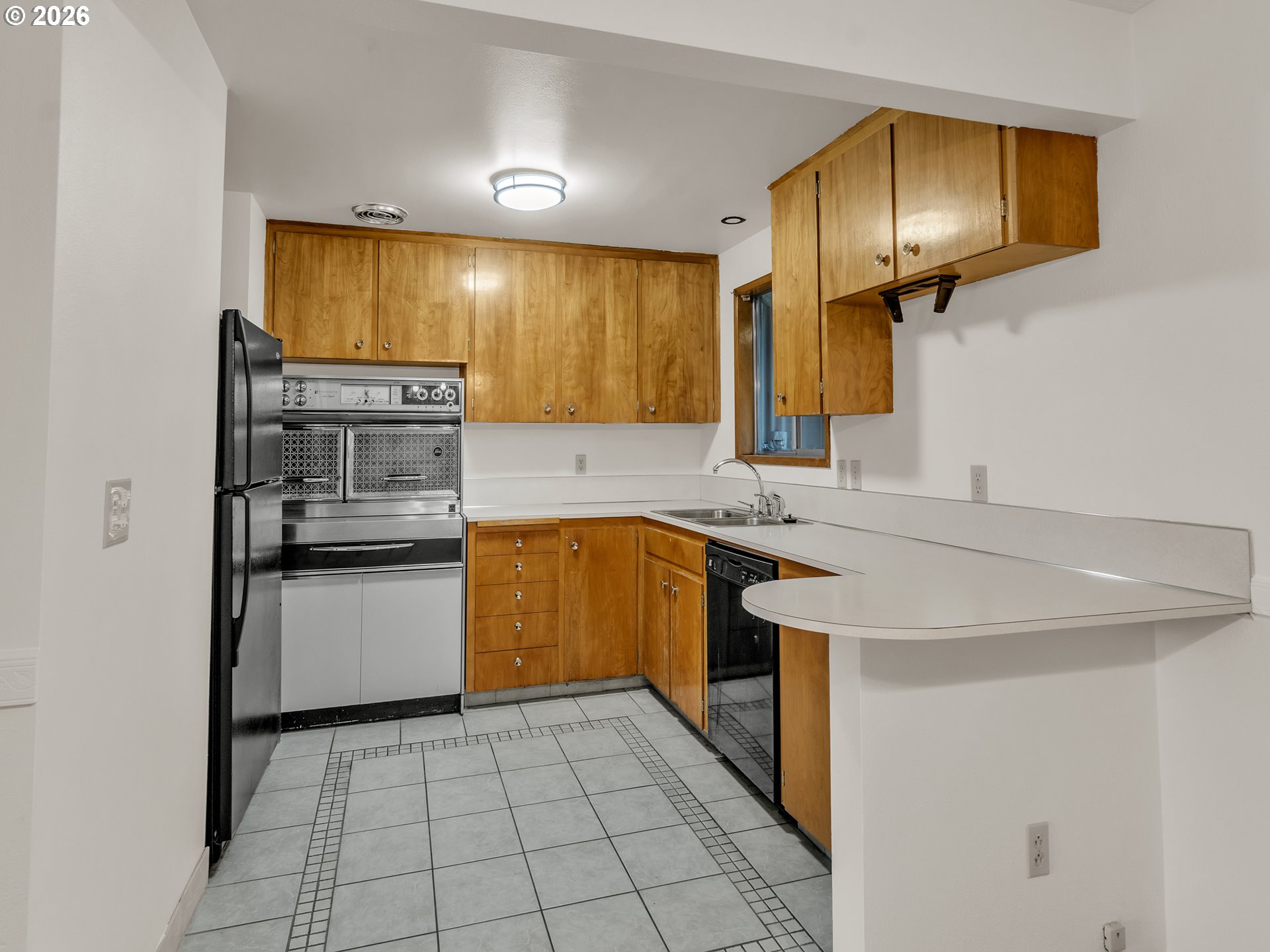1749 Thompson Road Woodburn, OR 97071 - Photo 15 of 33 a kitchen with a sink a stove top oven and cabinets