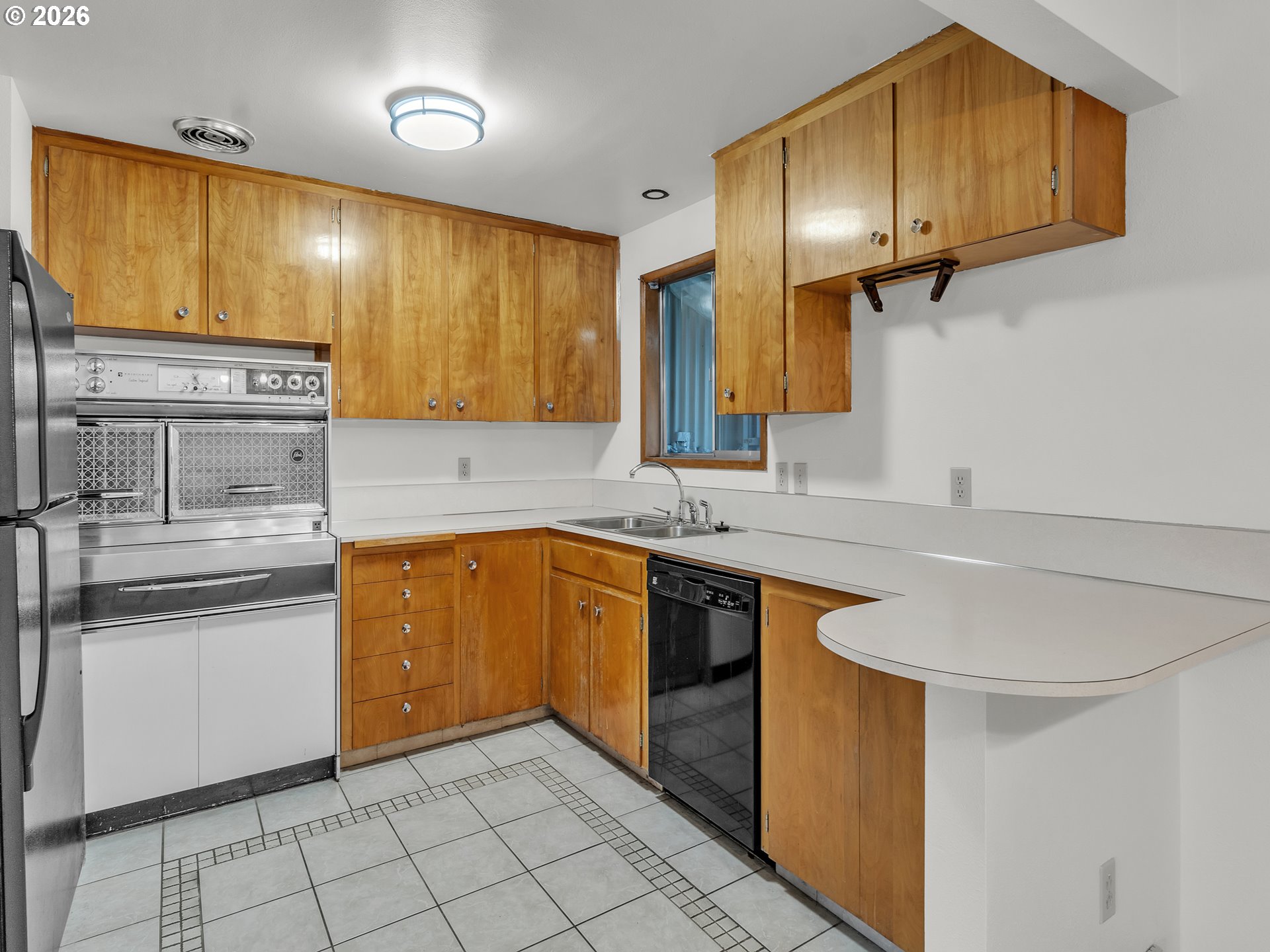1749 Thompson Road Woodburn, OR 97071 - Photo 16 of 33 a kitchen with stainless steel appliances granite countertop a sink a stove cabinets and a refrigerator