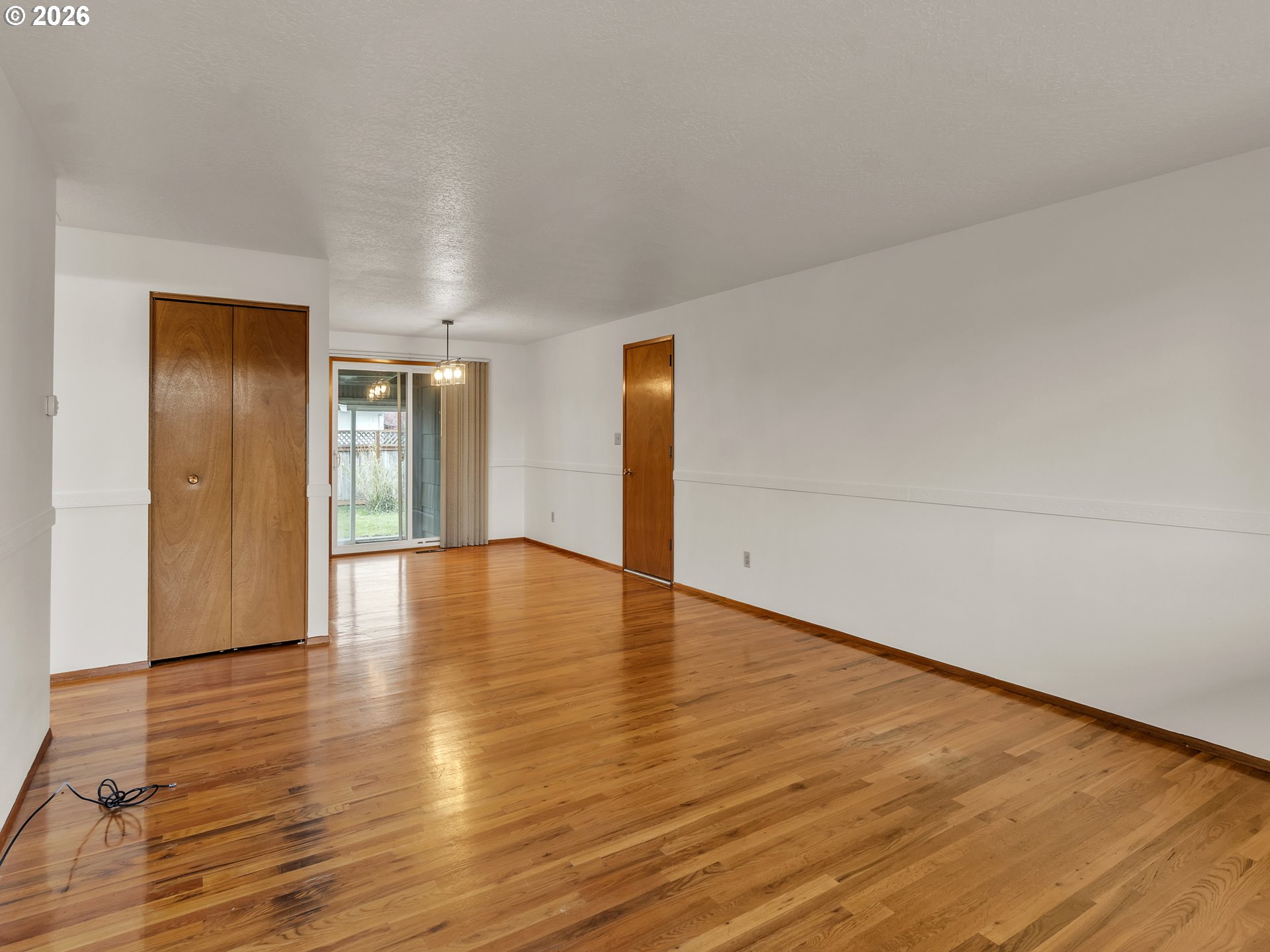 1749 Thompson Road Woodburn, OR 97071 - Photo 9 of 33 a view of empty room with wooden floor
