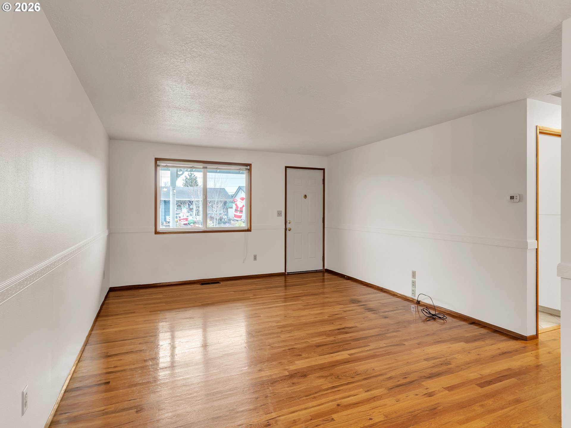 1749 Thompson Road Woodburn, OR 97071 - Photo 10 of 33 an empty room with wooden floor and windows